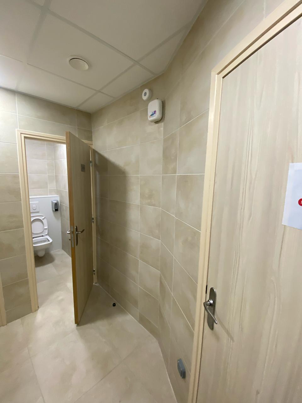 Diffuseur mural dans le passage desservant les cabines sanitaires